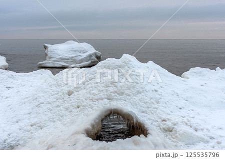Close-up shot of the Frozen ice blocks in Baltic sea water on the shore, Kaltene, Latvia Close-up shot of the Frozen ice blocks in Baltic sea water on the shore, Kaltene, Latvia 125535796