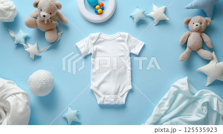 Baby white body suit on blue background with toys around. Cozy mockup, flat lay, top view 125535923