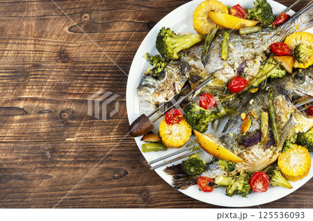 Roasted dorada fish with vegetables. Roasted dorada fish with vegetables. 125536093