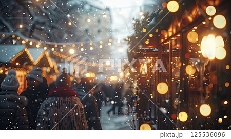 Christmas market covered in fresh snow. Festive lights glowing and people in warm clothes in cozy atmosphere 125536096