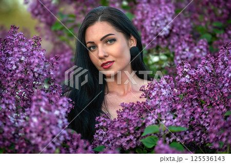Woman among lilac blossoms. Shallow depth of feld Woman among lilac blossoms. Shallow depth of feld 125536143