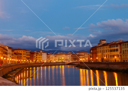 Panoramic view of the old town of Pisa and the Arno river at twilight, Italy. Night cityscape 125537135
