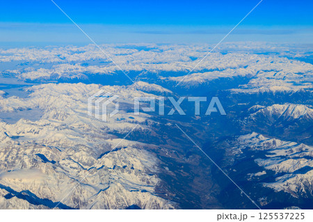 View of the Swiss Alps covered with snow from airplane 125537225