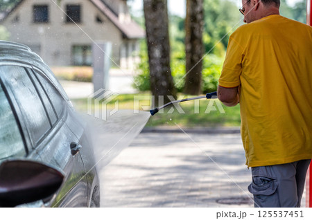 Manual wash for perfect clean car. Cleaning car using high pressure water. 125537451