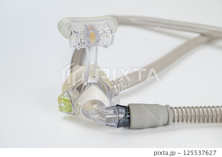 Respiratory mask for sleep disorders isolated over white. Apnea. Air pump. Assisted breathing. 125537627