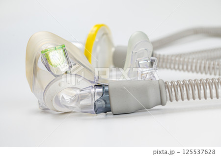 Respiratory mask for sleep disorders isolated over white. Apnea. Air pump. Assisted breathing. 125537628