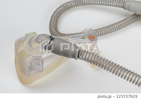 Respiratory mask for sleep disorders isolated over white. Apnea. Air pump. Assisted breathing. 125537629