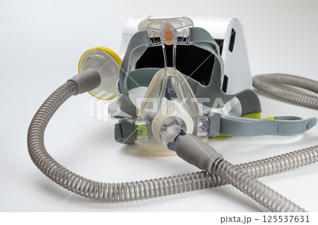 Continuous positive airway pressure system includes of CPAP machine, mask, tube on white background. 125537631