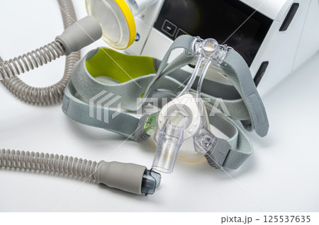 CPAP machine with mask and hose, for people with sleep apnea, respiratory, or breathing disorder 125537635