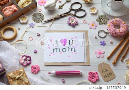 Charming handcrafted Mothers Day greeting card with delicate floral embellishments heart decorations and warm pastel colors ideal for expressing love and appreciation through a personalized touch Charming handcrafted Mothers Day greeting card with delicate floral embellishments heart decorations and warm pastel colors ideal for expressing love and appreciation through a personalized touch 125537949