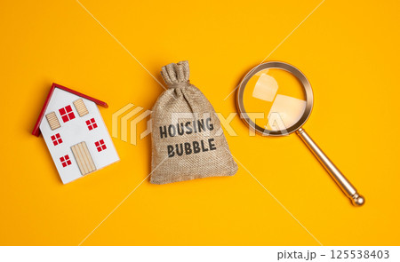 Housing bubble concept. Temporary period of rapidly rising home prices, driven by high demand, speculation, and excessive borrowing. Real estate. Money bag, house, and magnifying glass 125538403