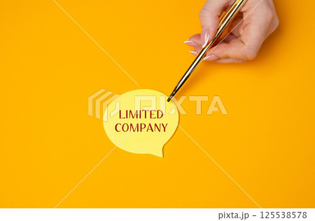 Limited company concept. Type of business structure where the company's liability is limited to the amount of money invested in the business by its shareholders. A woman points to a note with a pen 125538578