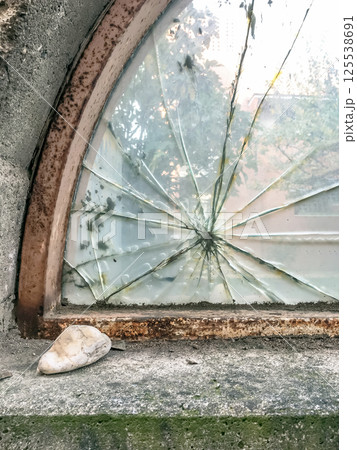 Broken glass with stone 125538691
