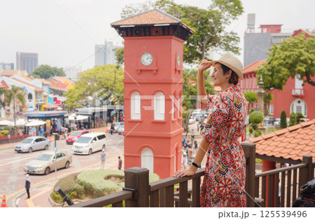 woman in dress and hat exploring vibrant streets of Malacca, Malaysia. woman in dress and hat exploring vibrant streets of Malacca, Malaysia. 125539496