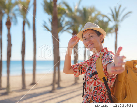 Woman strolls through colorful streets of Spanish coastal town Woman strolls through colorful streets of Spanish coastal town 125539632