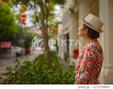woman exploring streets of George Town, during Chinese New Year. woman exploring streets of George Town, during Chinese New Year. 125539662