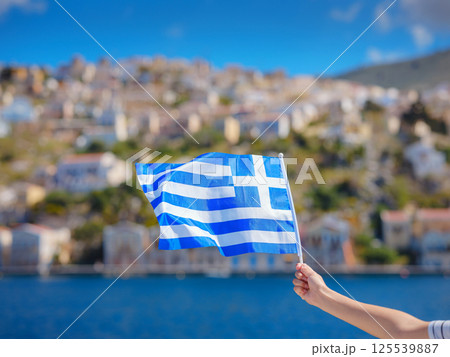 View of Greek flag waving in air serene Mediterranean vibe. View of Greek flag waving in air serene Mediterranean vibe. 125539887