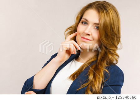 Business woman in suit looking at camera Business woman in suit looking at camera 125540560