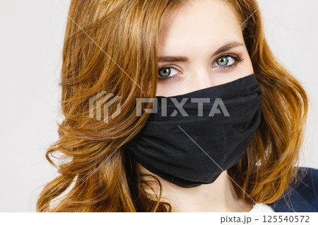 Female using protective face mask. Female using protective face mask. 125540572