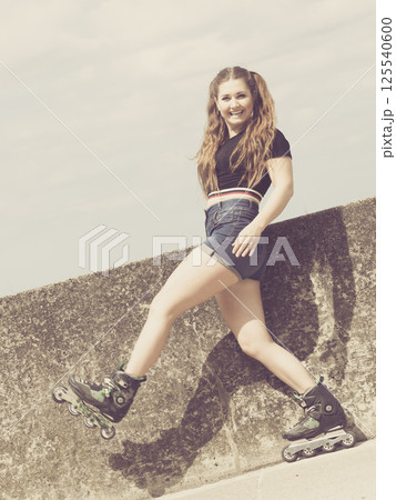 Fit girl with roller skates outdoor 125540600