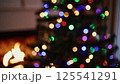 Vibrant christmas lights bokeh soft focus glowing multicolor circles blurred fireplace background festive party atmosphere abstract holiday pattern shimmer 125541291