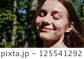 Woman enjoying morning sunlight nature therapy forest meditation practice mindfulness wellness journey spiritual awakening peaceful moment self discovery healing positive energy 125541292
