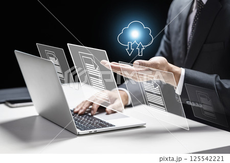 Businessman using a laptop while showing an icon of a cloud and files. Technology innovation on a virtual screen. Concept of data management system 125542221