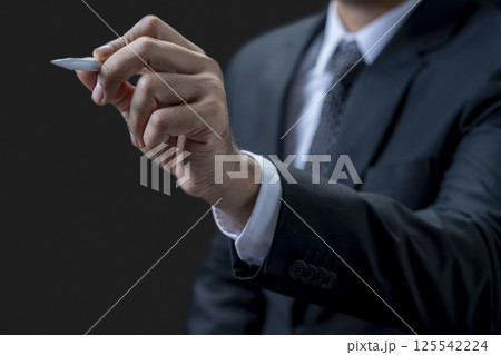 Businessman with a pen pointing or touching the blank area. Copy space. Business concept Businessman with a pen pointing or touching the blank area. Copy space. Business concept 125542224
