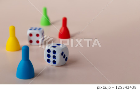 A board game of dice and chips on a light background. Time to rest. 125542439
