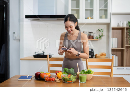 Fit woman enjoys healthy fruit breakfast after yoga training. fitness, nutrition, healthy lifestyle. 125542646