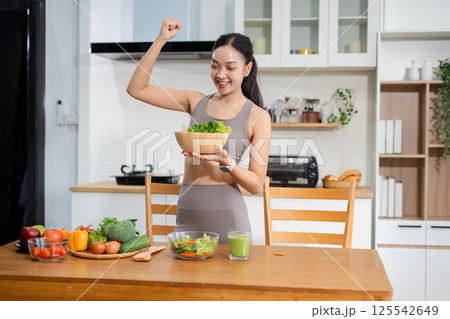 Fit woman enjoys healthy fruit breakfast after yoga training. fitness, nutrition, healthy lifestyle. 125542649