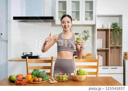 Fit woman enjoys healthy fruit breakfast after yoga training. fitness, nutrition, healthy lifestyle. Fit woman enjoys healthy fruit breakfast after yoga training. fitness, nutrition, healthy lifestyle. 125542657