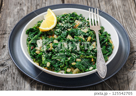 sauteed kale with garlic, onion, red pepper flakes sauteed kale with garlic, onion, red pepper flakes 125542705
