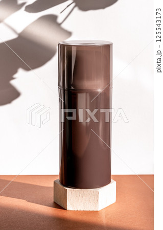 Brown cosmetic shower gel bottle on wooden geometric pedestal podium, product packaging with natural shadows from plants, antiperspirant for men, shaving foam, shampoo mockup Brown cosmetic shower gel bottle on wooden geometric pedestal podium, product packaging with natural shadows from plants, antiperspirant for men, shaving foam, shampoo mockup 125543173