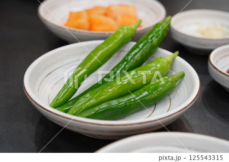 Green Chilies in a White Bowl 125543315