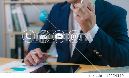 Contact us or email marketing concept, Website page, Customer support hotline, Contact us laptop online, Businessman sitting and working on tablet and laptop, Email, Phone, Address, Chat message icon. Contact us or email marketing concept, Website page, Customer support hotline, Contact us laptop online, Businessman sitting and working on tablet and laptop, Email, Phone, Address, Chat message icon. 125543404