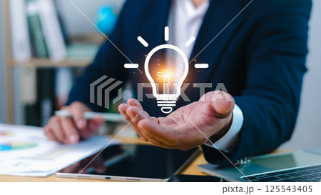 Innovation through ideas and inspiration ideas, Idea of creativity and inspiration concept of sustainable business development, Human hand holding light bulb to illuminate, Creative solutions. 125543405