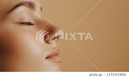 Profile of a beautiful young woman with freckles breathing with closed eyes, showcasing the results of rhinoplasty surgery and highlighting natural beauty and cosmetology 125543908