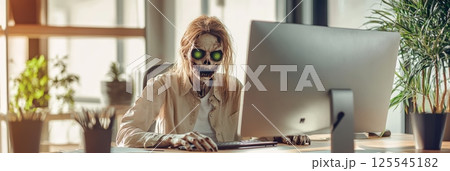 Zombie office worker with glowing green eyes using computer in a post apocalyptic office setting, highlighting the eerie concept of survival in a decayed world 125545182