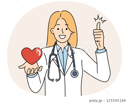 Woman doctor from in hospital with heart in hand smiling and showing thumb up 125545184