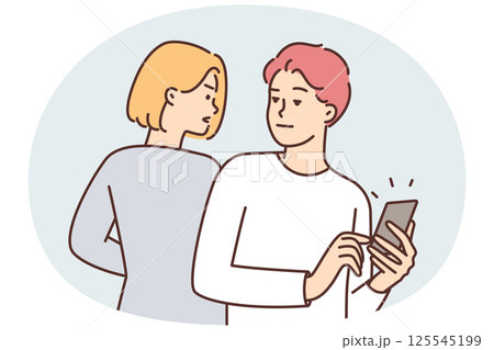 Curious woman trying to spy on boyfriend chatting or using social media on phone 125545199