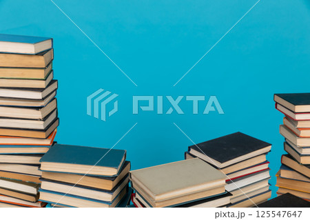 Stacks of books on the blue background of the university library 125547647