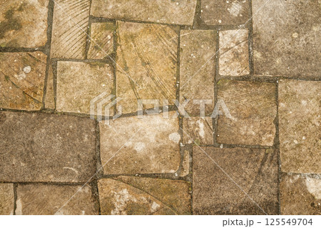 Antique ancient stone wall masonry texture background. Old wall made of beige stone blocks  125549704