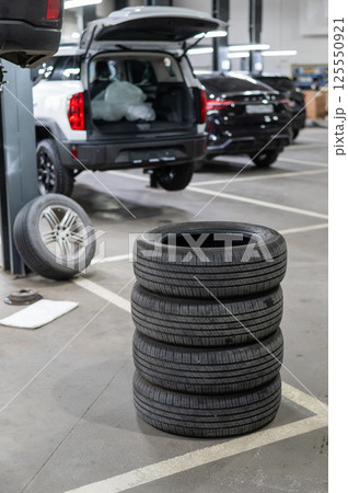 Changing tires for a car according to the season.  125550921