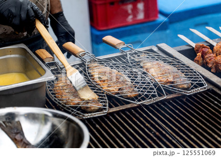 Grilling Fish on Barbecue Grill Baskets 125551069