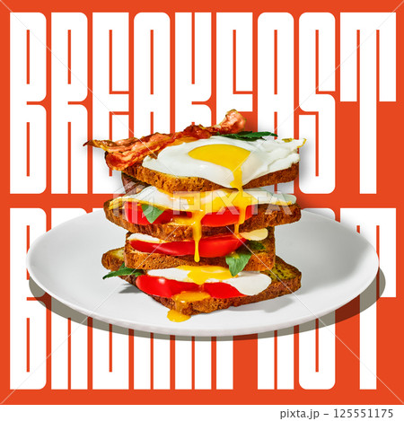 Stacked toast sandwich with fried eggs bacon basil and tomatoes melting together on clean plate. Bold breakfast lettering. Stacked toast sandwich with fried eggs bacon basil and tomatoes melting together on clean plate. Bold breakfast lettering. 125551175