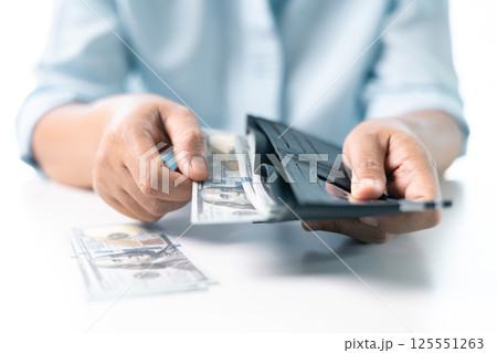 She carefully counted the dollar bills in her hand, managing her business finances and prioritizing saving for future investments. dollar, finance, money, cash, currency, bill, banknote, business. She carefully counted the dollar bills in her hand, managing her business finances and prioritizing saving for future investments. dollar, finance, money, cash, currency, bill, banknote, business. 125551263