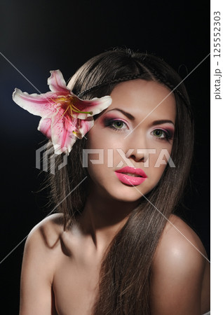 beauty with orchid in a dark 125552303