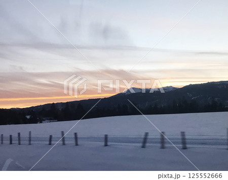 Sunset on the road from Brundage Mountain ski resort. View from the car. Sunset on the road from Brundage Mountain ski resort. View from the car. 125552666