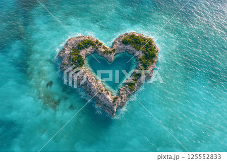 Heart-shaped island surrounded by turquoise water in a tropical setting 125552833